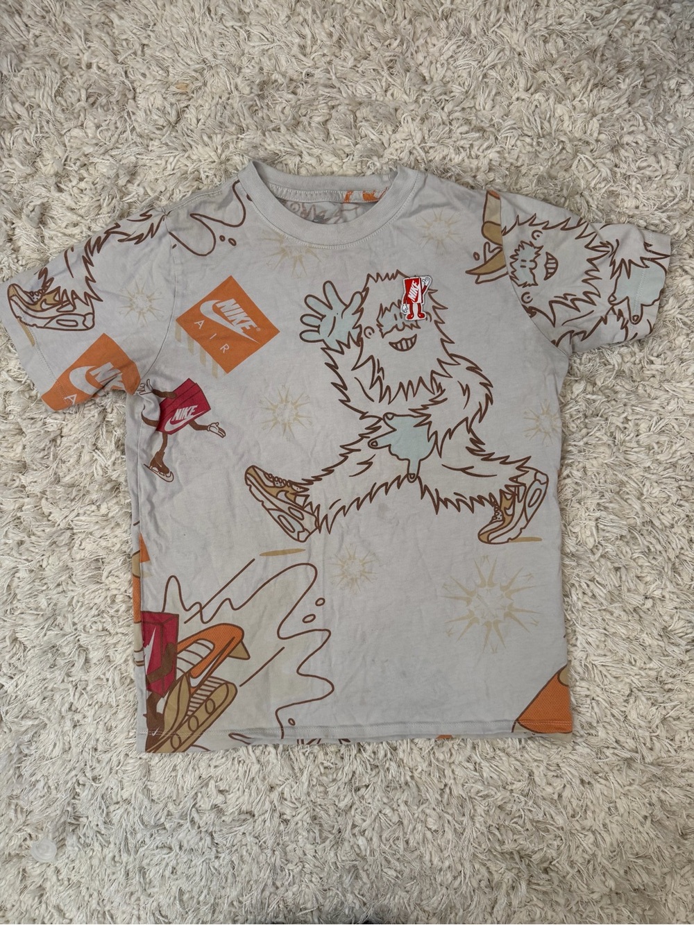 Nike Kids Short Sleeve Tee in Light Gray with Orange & Brown Graphics